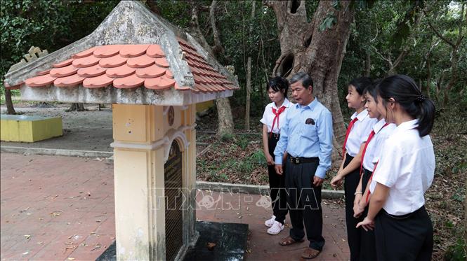 Ông Nguyễn Minh Việt, người gắn bó nhiều năm với Rừng cây Bác Hồ chia sẻ những câu chuyện lịch sử cách mạng với các em học sinh. Ảnh: Đỗ Trưởng – TTXVN