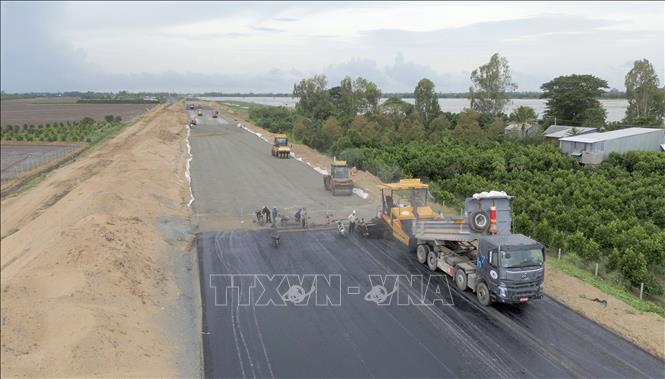 Tranh thủ thời tiết thuận lợi, Tổng Công ty Xây dựng Trường Sơn tập trung  thảm bê tông nhựa những vị trí đạt yêu cầu kỹ thuật, nhằm đẩy nhanh tiến độ. Ảnh: Công Mạo - TTXVN