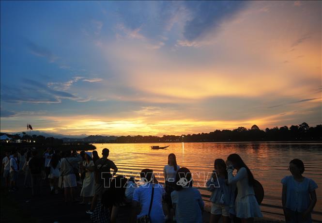 Đông đảo du khách đến bờ Nam sông Hương, thành phố Huế ngắm cảnh đẹp của hoàng hôn. Ảnh: Nguyên Lý - TTXVN