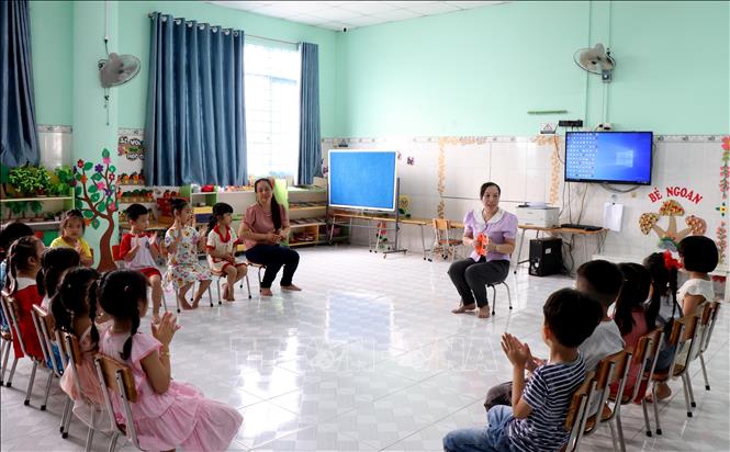 Giáo viên Trường Mầm non Măng non (phường Long Châu) cho trẻ sinh hoạt, làm quen môi trường học trước ngày khai giảng năm học mới. Ảnh: Lê Thúy Hằng – TTXVN.