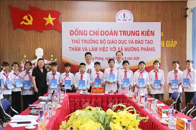 Thứ trưởng Bộ Giáo dục và Đào tạo Đoàn Trung Kiên cùng đoàn công tác tặng quà cho học sinh Trường Trung học cơ sở Võ Nguyên Giáp. Ảnh: TTXVN phát