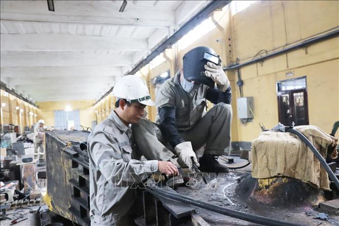 Vũ Văn Phong, Tổ trưởng sửa chữa thuộc Xưởng sửa chữa, Công ty Xi măng Hoàng Thạch đang hướng dẫn đồng nghiệp trong thực hiện nhiệm vụ chuyên môn. Ảnh: Mạnh Tú - TTXVN