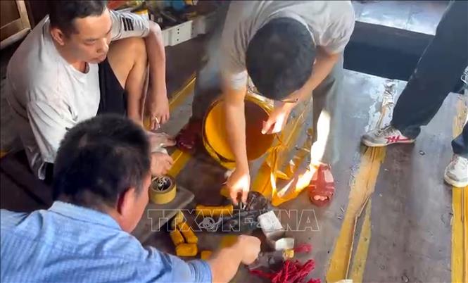 Lực lượng chức năng thu giữ kíp nổ, thuốc nổ trên tàu cá NA-95588-TS do Bùi Văn Nhạ (sinh năm 1982) là chủ tàu, kiêm thuyền trưởng. Ảnh: TTXVN phát