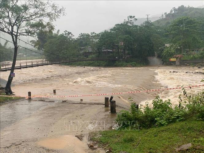 Nhiều đập tràn trên địa bàn tỉnh Lào Cai nước dâng cao, lực lượng chức năng căng dây không cho người và phương tiện lưu thông. Ảnh: TTXVN phát