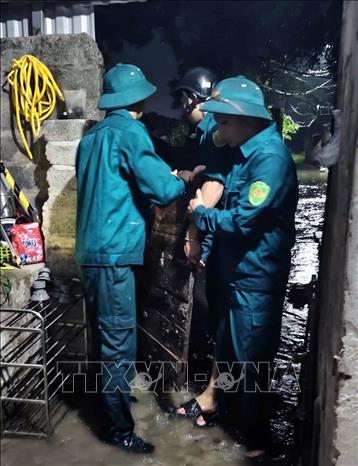 Ban quân sự Phường Châu Sơn tham gia giúp dân di chuyển đồ đạc đến nơi an toàn do mưa ngập khu vực sông Đáy. Ảnh: Đại Nghĩa - TTXVN