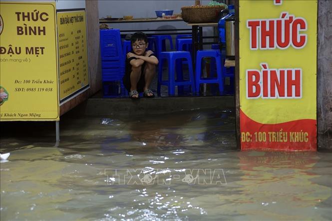 Phố Triều Khúc, phường Thanh Liệt vẫn ngập sâu, cuộc sống của người dân bị ảnh hưởng, các phương tiện giao thông gặp khó khăn khi đi qua tuyến đường này. Ảnh: Tuấn Anh - TTXVN