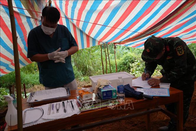 Lực lượng pháp y triển khai nghiệp vụ tại khu vực có nhiều mộ liệt sĩ tại đồi Đá Vôi, phường Cam đường. Ảnh: Hồng Ninh - TTXVN