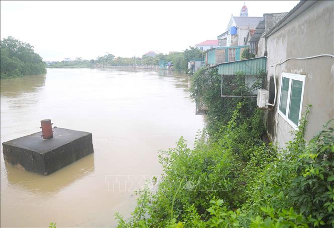 Mực nước đoạn cuối sông Bùng chảy qua địa phận xã Đức Châu (Nghệ An) dâng cao, dần nhấn chìm ụ nổi trong Khu neo đậu cho tàu thuyền tránh trú bão trên luồng tuyến Lạch Vạn. Ảnh: Xuân Tiến - TTXVN 
