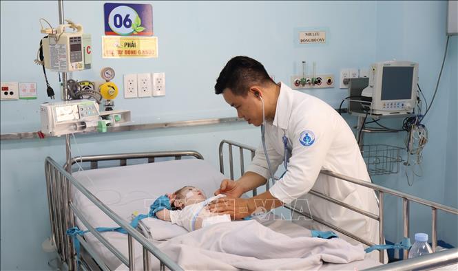 Bác sĩ Dư Tuấn Quy, Trưởng Khoa Nhiễm - Thần kinh, Bệnh viện Nhi đồng 1 Thành phố Hồ Chí Minh kiểm tra tình trạng bệnh cho bệnh nhi nặng phải nằm phòng cấp cứu. Ảnh: Đinh Hằng - TTXVN