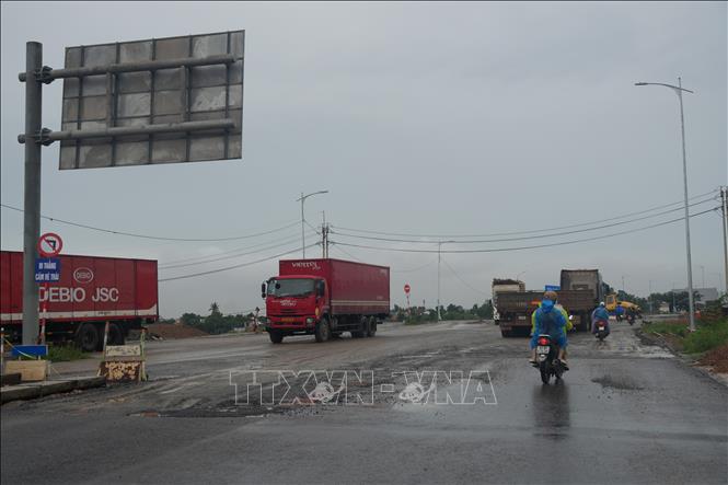 Mật độ xe tải trọng lớn và xe container lưu thông cao trong khi lòng đường bị thu hẹp do rào chắn, tập kết vật liệu dồn ứ dễ dẫn đến ùn tắc giờ cao điểm. Ảnh: Anh Dũng - TTXVN