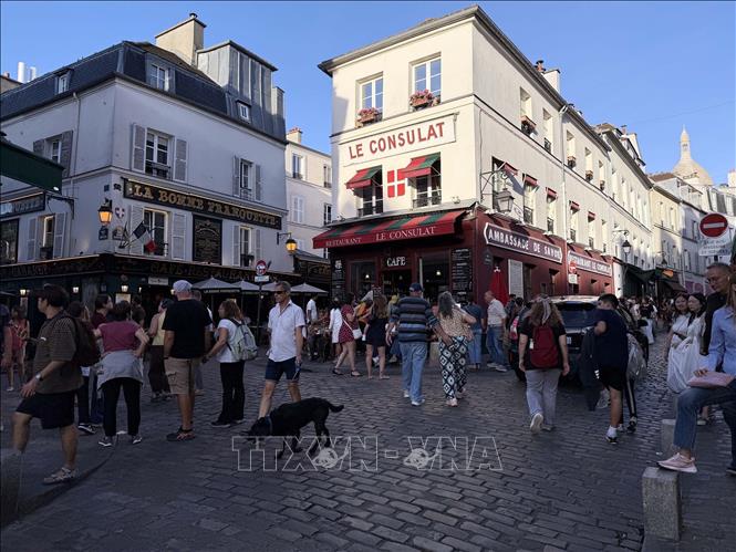 Dòng du khách trên những con phố lát đá với các quán cà phê, nhà hàng đặc trưng của khu Montmartre. Ảnh: Hữu Chiến - PV TTXVN tại Pháp