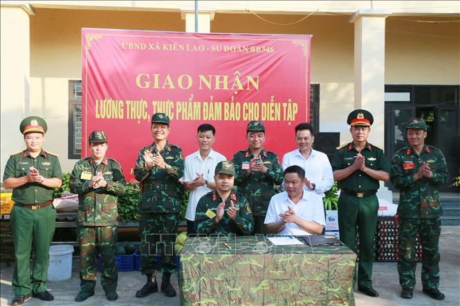 Đại diện lãnh đạo, chỉ huy Sư đoàn 346 và xã Kiên Lao, tỉnh Bắc Ninh ký kết giao nhận lương thực, thực phẩm phục vụ bộ đội hành quân, dã ngoại. Ảnh: Trọng Đức - TTXVN