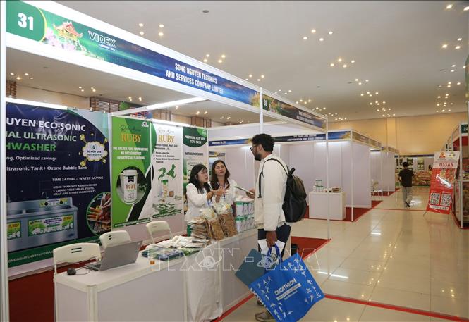 Khách tham quan tìm hiểu các mặt hàng được trưng bày tại hội chợ. Ảnh: Minh Hưng - PV TTXVN tại Campuchia