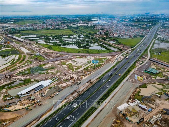 Công trường thi công nút giao Vành đai 4 – Pháp Vân – Cầu Giẽ nằm hai bên tuyến cao tốc đang khai thác. Ảnh: Vũ Quang - TTXVN
