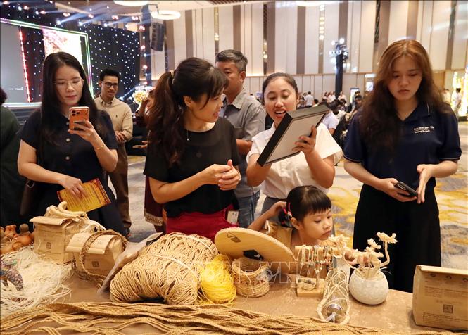 Doanh nghiệp giới thiệu các sản phẩm đồ lưu niệm mới của Hội An tại Hội thảo. Ảnh: Trần Lê Lâm - TTXVN 