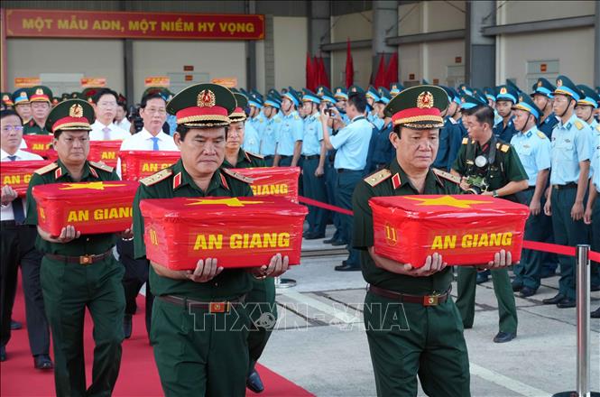 Trung tướng Nguyễn Xuân Dắt, Tư lệnh Quân khu 9 và Trung tướng Hồ Văn Thái, Chính ủy Quân khu 9 đưa mẫu sinh phẩm hài cốt liệt sĩ lên máy bay quân sự. Ảnh: Thanh Liêm - TTXVN