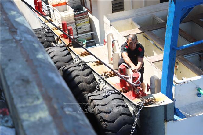 Ngư dân buộc lại dây neo của tàu cá tại cảng ở thành phố Hạ Môn, tỉnh Phúc Kiến, Trung Quốc, ngày 21/10/2026. Ảnh: THX/TTXVN phát
