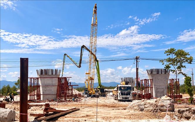 Nhà thầu thi công cầu vượt Quốc lộ 1A và đường sắt Bắc – Nam tăng cường phương tiện, thiết bị, nhân lực, đẩy nhanh tiến độ, phấn đấu gác dầm đầu tiên trước ngày 15/11. Ảnh: Nguyên Linh-TTXVN