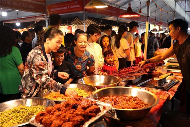 Người dân cùng du khách thưởng thức sản phẩm ẩm thực tại các gian hàng của huyện Kim Bình, tỉnh Lai Châu. Ảnh: Quý Trung - TTXVN
